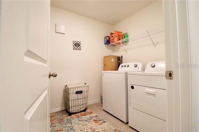 clothes washing area featuring independent washer and dryer and light tile patterned floors