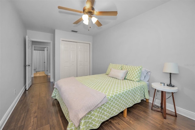 bedroom with a closet, ceiling fan, and dark hardwood / wood-style flooring