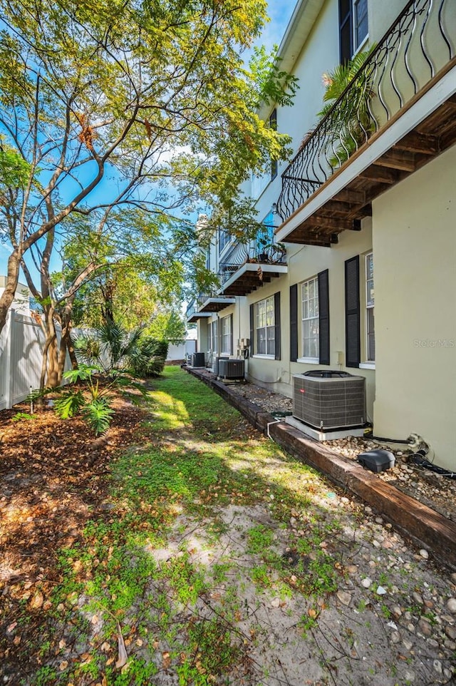 view of yard featuring a balcony and cooling unit