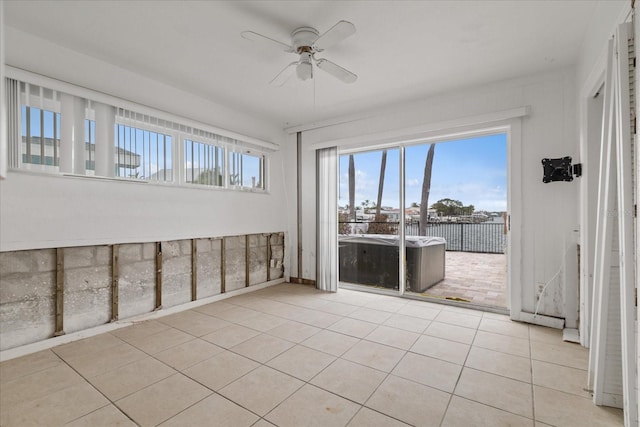 unfurnished sunroom with ceiling fan