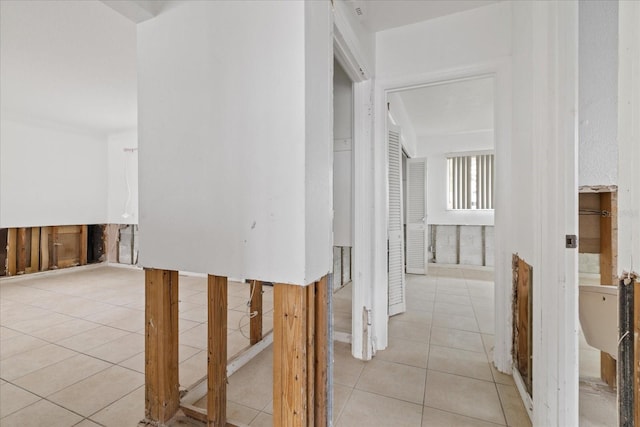 hall featuring light tile patterned floors