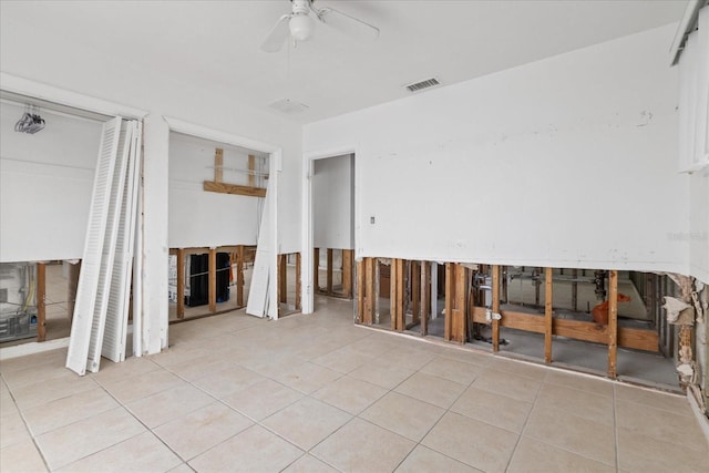 empty room featuring ceiling fan and light tile patterned floors