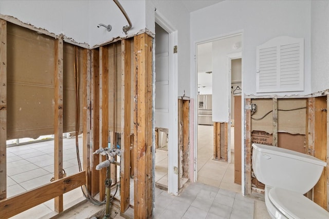 bathroom with tile patterned floors and toilet