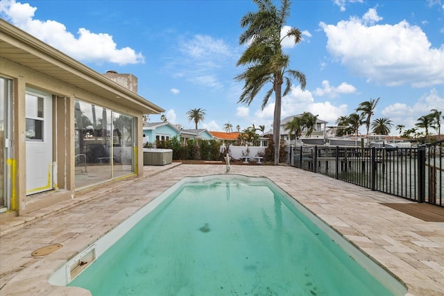 view of pool with a patio area and a water view