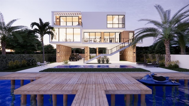 rear view of house featuring a patio, stairway, a balcony, fence, and stucco siding