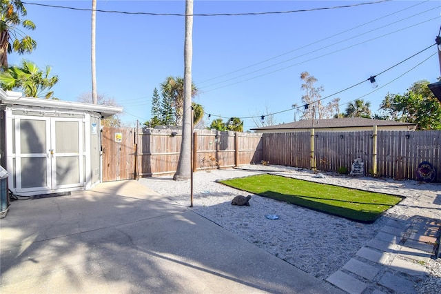 view of yard featuring a patio and a storage shed