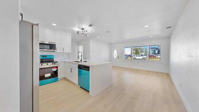 kitchen featuring kitchen peninsula, white cabinetry, light hardwood / wood-style flooring, and appliances with stainless steel finishes