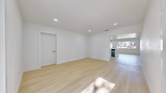 empty room with light hardwood / wood-style floors