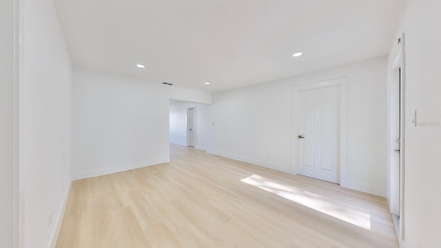 spare room featuring light hardwood / wood-style floors