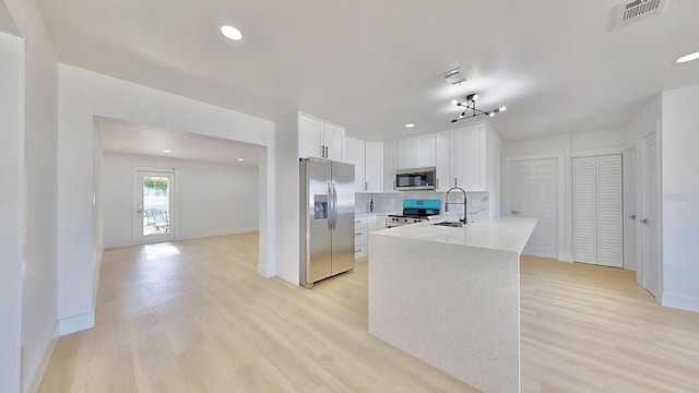 kitchen with light hardwood / wood-style floors, sink, white cabinetry, and stainless steel appliances