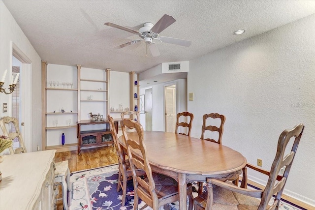 dining space featuring ceiling fan, a textured ceiling, and light hardwood / wood-style flooring