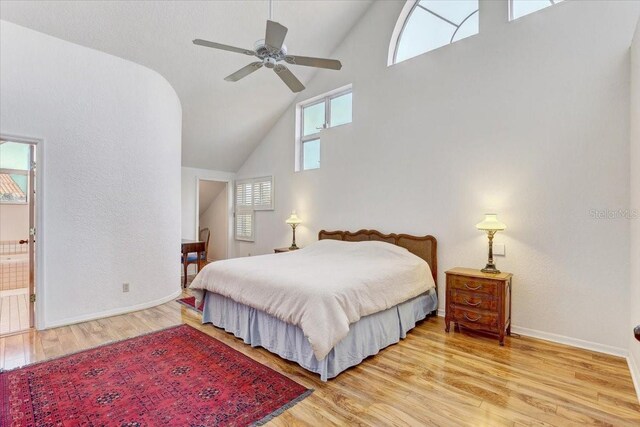 bedroom with ceiling fan, light hardwood / wood-style floors, and ensuite bath