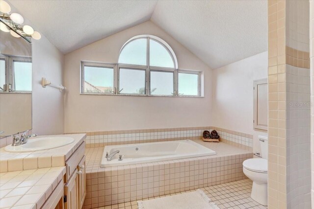 bathroom featuring tile patterned floors, a textured ceiling, lofted ceiling, toilet, and vanity