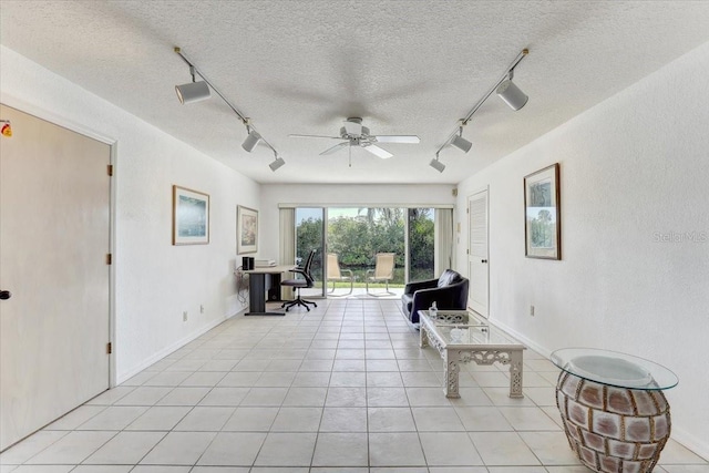 sitting room with ceiling fan, light tile patterned flooring, a textured ceiling, and track lighting