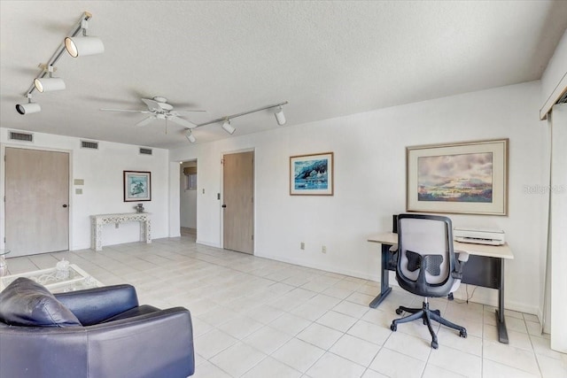 tiled office space featuring ceiling fan, a textured ceiling, and track lighting