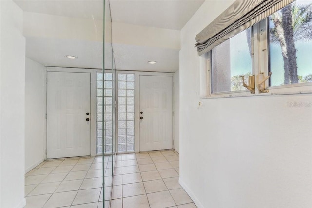 tiled entryway with a wealth of natural light