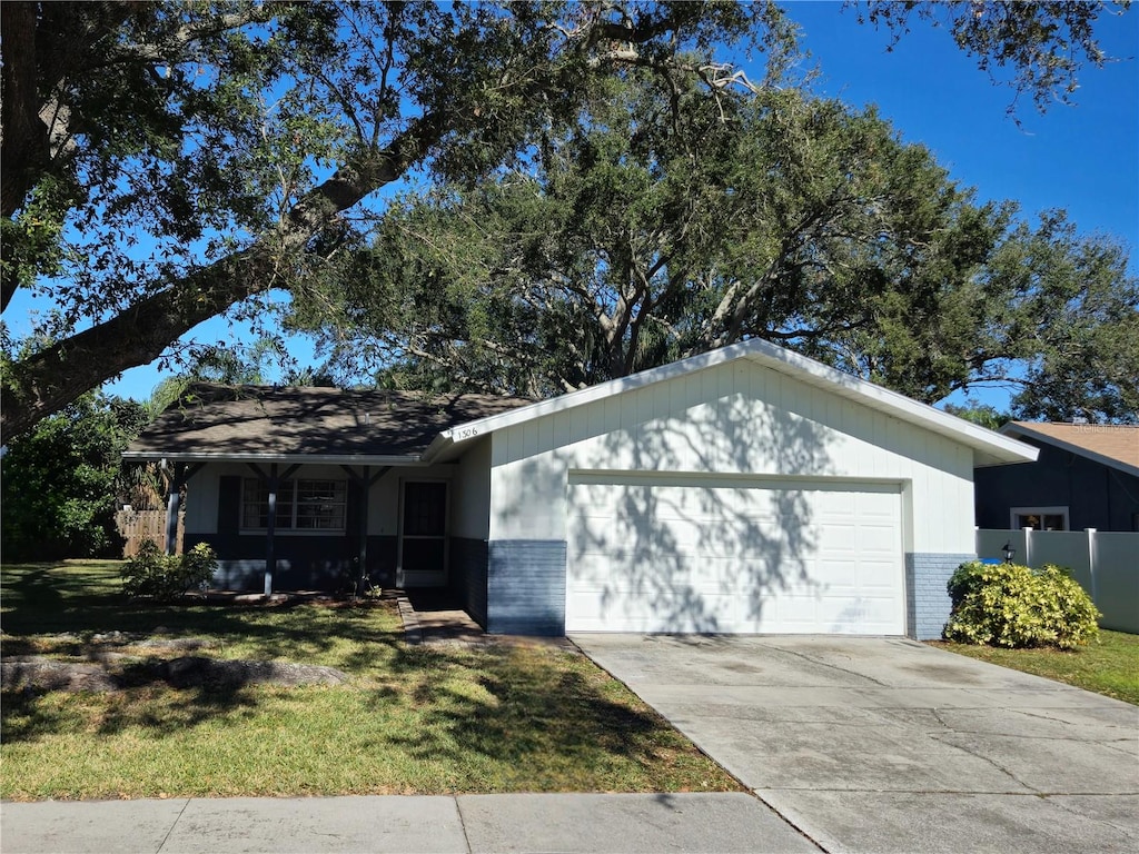 ranch-style house featuring a front yard and a garage