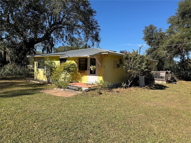 back of property featuring a lawn