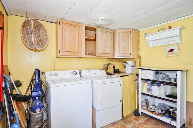 laundry area featuring washer and clothes dryer and cabinets