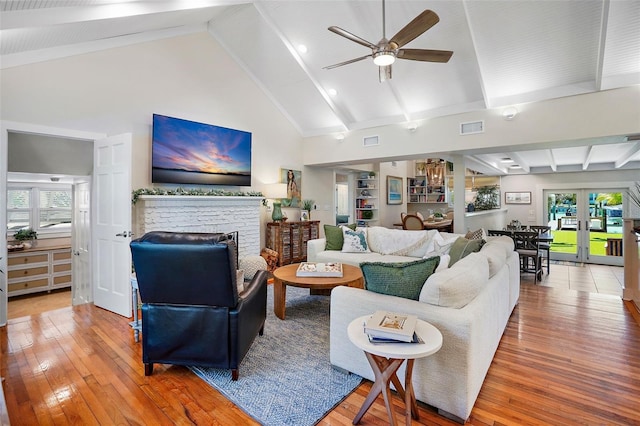 living room featuring ceiling fan, french doors, plenty of natural light, and high vaulted ceiling