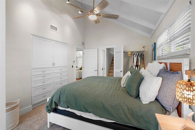 bedroom featuring ceiling fan, beam ceiling, light colored carpet, and high vaulted ceiling