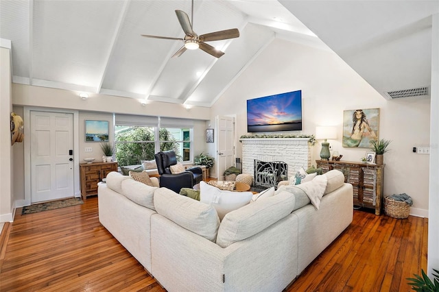 living room with ceiling fan, wood-type flooring, high vaulted ceiling, and a fireplace