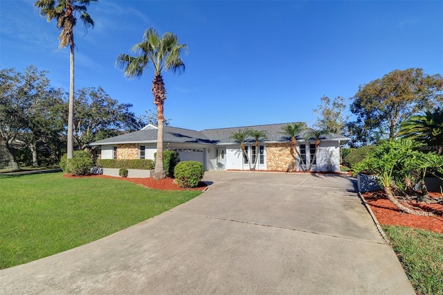 ranch-style house featuring a front yard and a garage