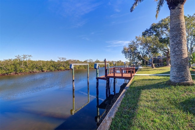 dock area with a water view and a lawn