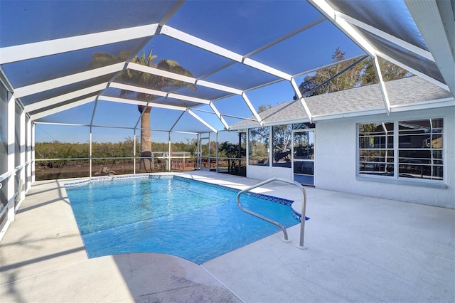 view of swimming pool with glass enclosure and a patio