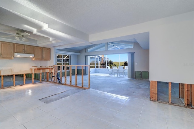 interior space with ceiling fan, a textured ceiling, and lofted ceiling