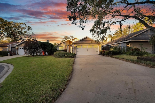 ranch-style house featuring a yard and a garage