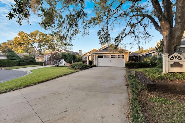 ranch-style home featuring a garage and a front lawn