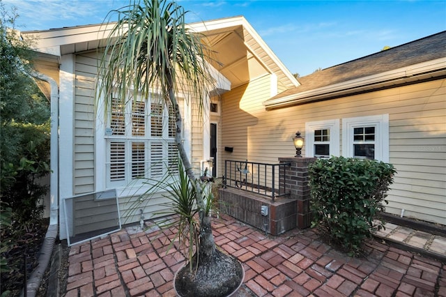 doorway to property with a porch and a patio