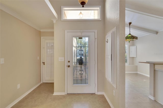 entryway with vaulted ceiling with beams, light tile patterned floors, and ornamental molding