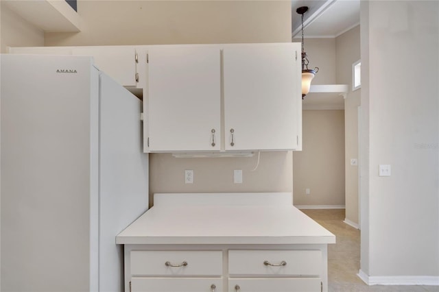 kitchen with white cabinets, pendant lighting, and white refrigerator