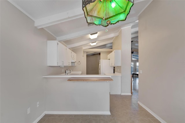 kitchen featuring white cabinetry, vaulted ceiling with beams, white refrigerator, kitchen peninsula, and light tile patterned floors