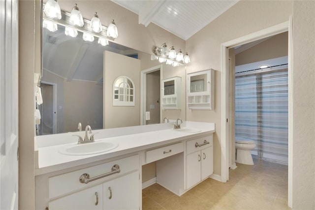 bathroom featuring tile patterned flooring, vanity, toilet, and vaulted ceiling