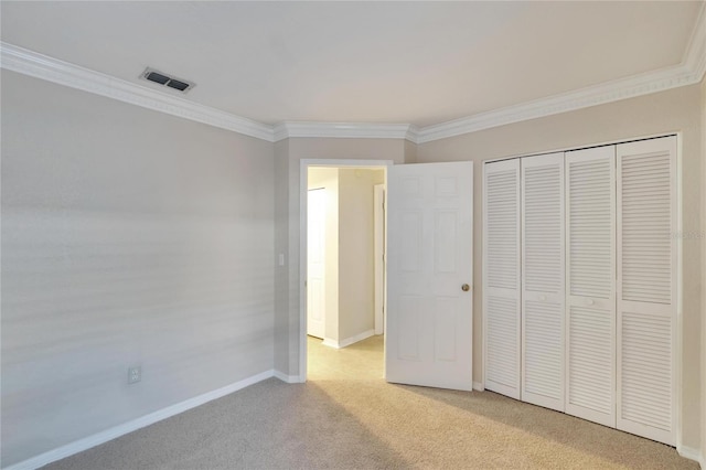 unfurnished bedroom featuring light carpet, a closet, and ornamental molding