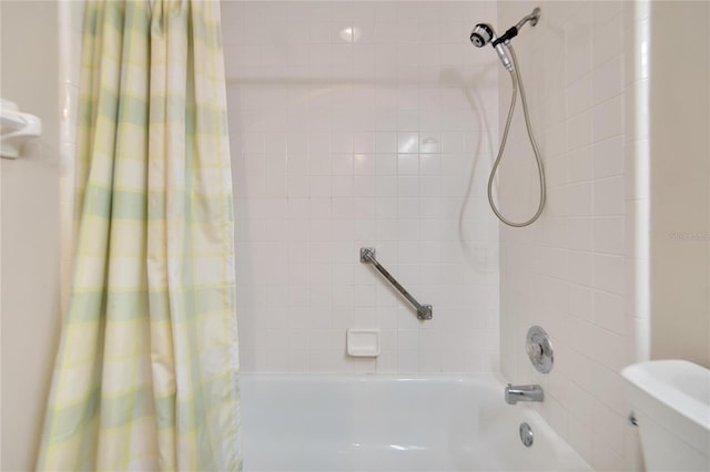 bathroom featuring shower / bath combination with curtain and toilet