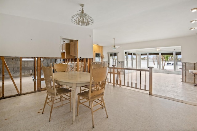 dining area with ceiling fan with notable chandelier