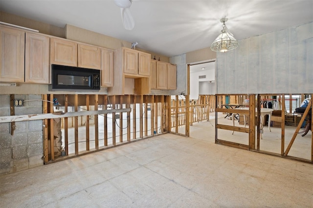 kitchen with pendant lighting, ceiling fan with notable chandelier, and light brown cabinets