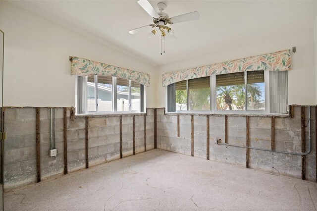 carpeted empty room featuring ceiling fan and vaulted ceiling