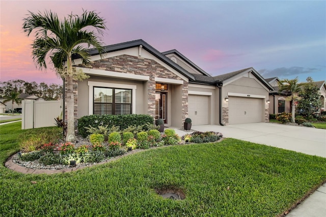 view of front of house featuring a garage and a yard