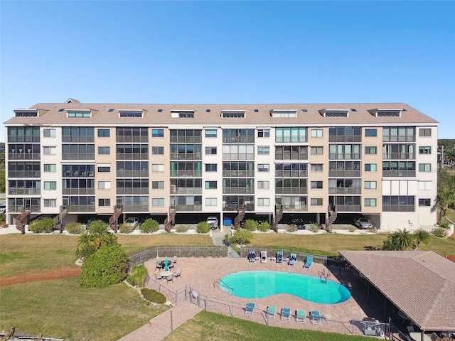 view of property featuring a community pool