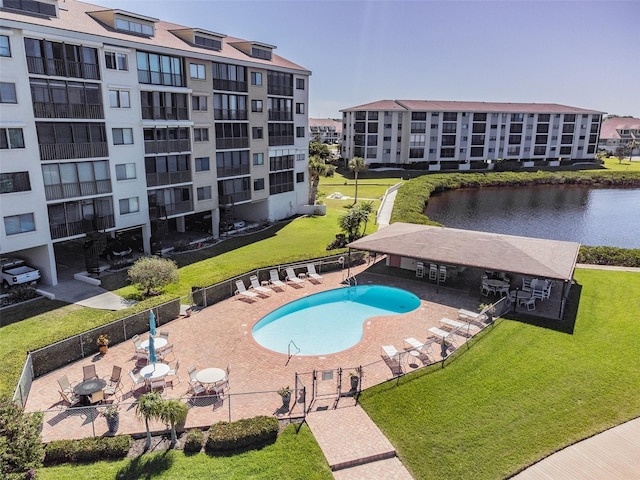 view of pool with a patio area and a water view