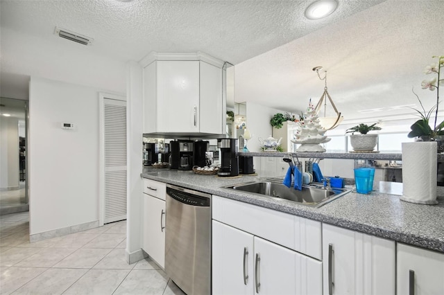 kitchen featuring white cabinets, a textured ceiling, stainless steel dishwasher, and sink