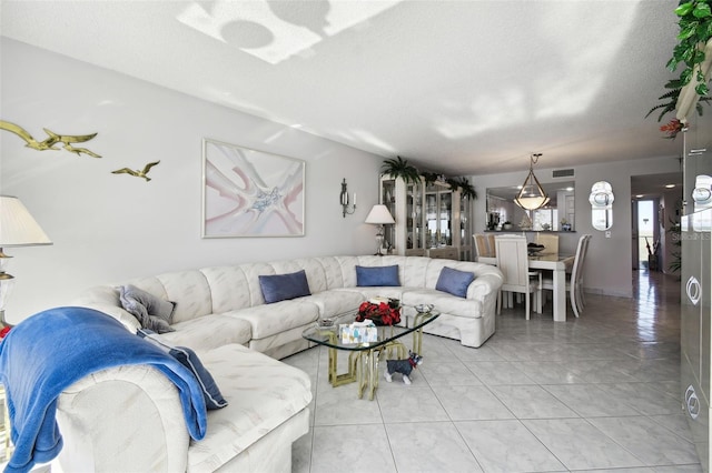 living room featuring light tile patterned floors and a textured ceiling