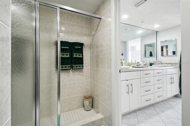 bathroom featuring vanity, tile patterned floors, and walk in shower