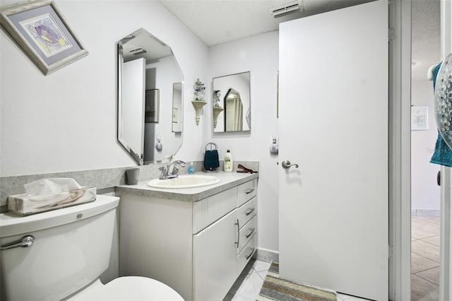 bathroom with tile patterned floors, vanity, and toilet