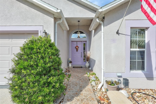 doorway to property featuring a garage